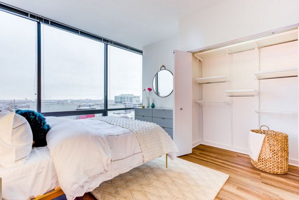 Spacious bedroom with modern decor at SoNo East Apartments