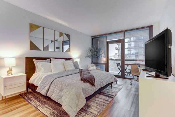 Contemporary bedroom with chic furnishings at SoNo East Apartments in Chicago
