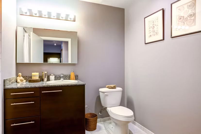 Bathroom featuring modern fixtures and large vanity at SoNo East Apartments