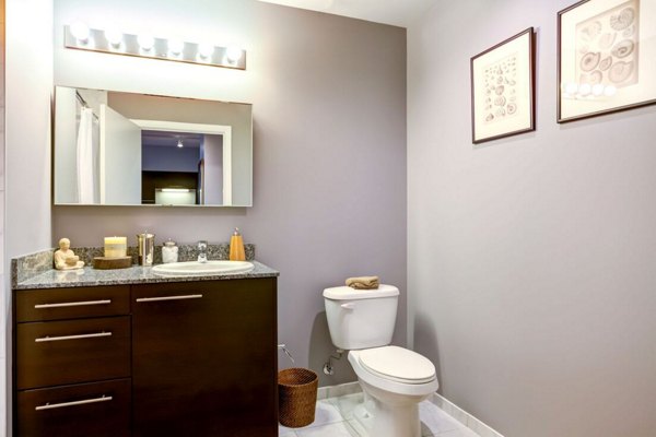 Bathroom featuring modern fixtures and large vanity at SoNo East Apartments