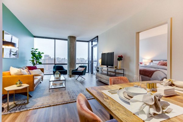 Dining area with sleek furnishings and modern lighting at SoNo East Apartments, offering luxury living in downtown Chicago