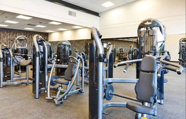 Modern fitness center featuring cardio and strength equipment at SoNo East Apartments