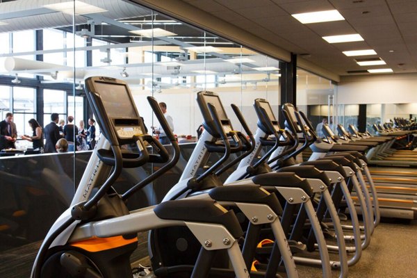 Modern fitness center with state-of-the-art equipment at SoNo East Apartments