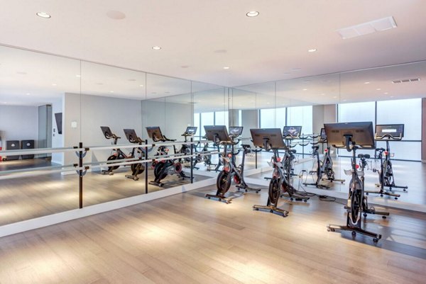 Yoga and spin studio with modern equipment at SoNo East Apartments, offering luxury fitness amenities for residents in Chicago