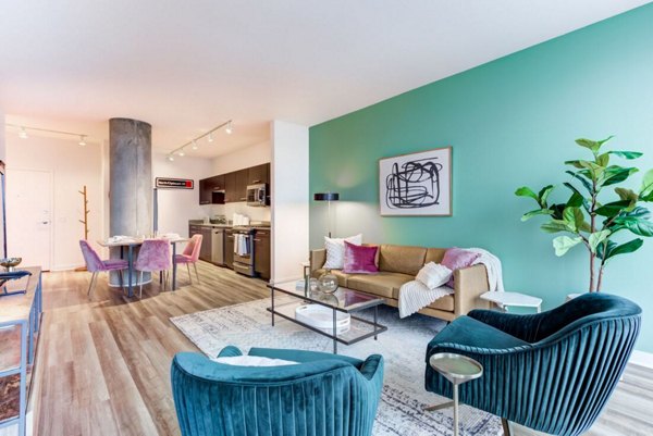 Inviting living room with contemporary furniture and large windows at SoNo East Apartments