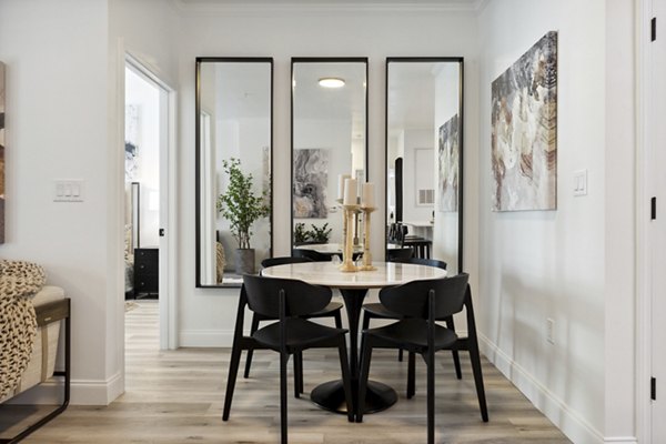 Elegant dining area with modern seating and ambient lighting at Verde Vista Apartments