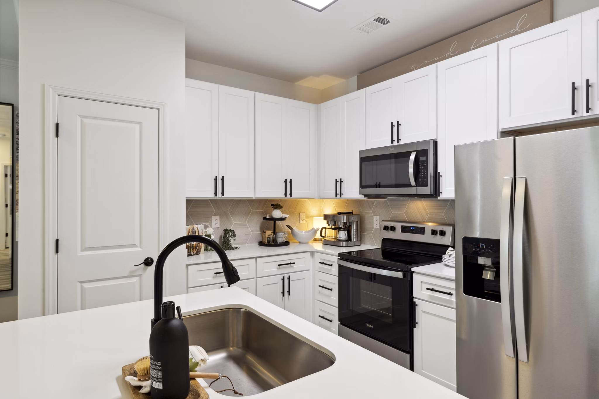 Modern kitchen with stainless steel appliances at Verde Vista Apartments, luxury living spaces by Greystar