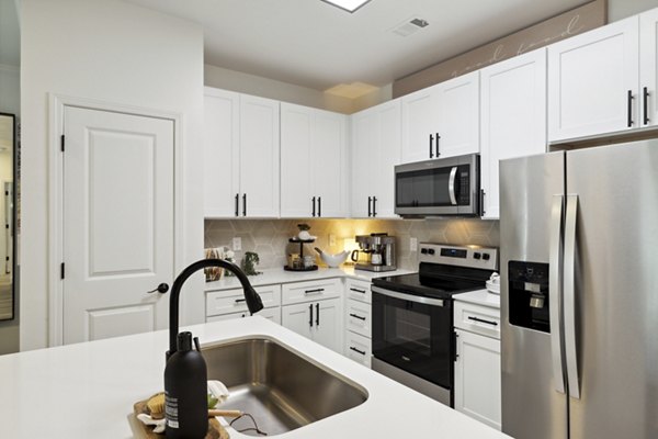 Modern kitchen with stainless steel appliances at Verde Vista Apartments, luxury living spaces by Greystar
