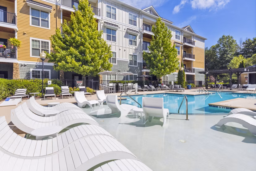 Resort-style outdoor pool with lounge chairs at Verde Vista Apartments