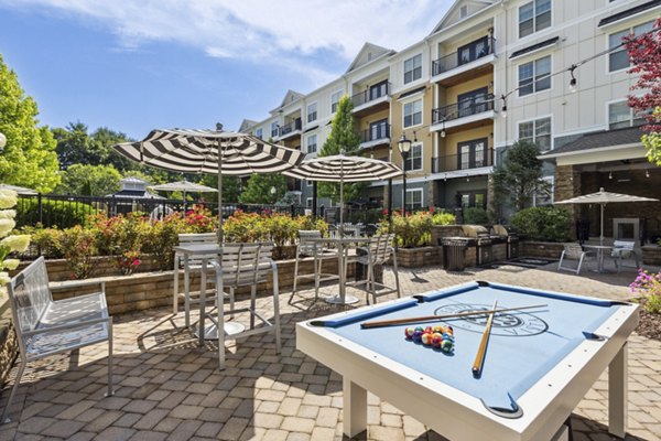Spacious outdoor patio at Verde Vista Apartments featuring modern seating and lush landscaping, perfect for relaxation and gatherings