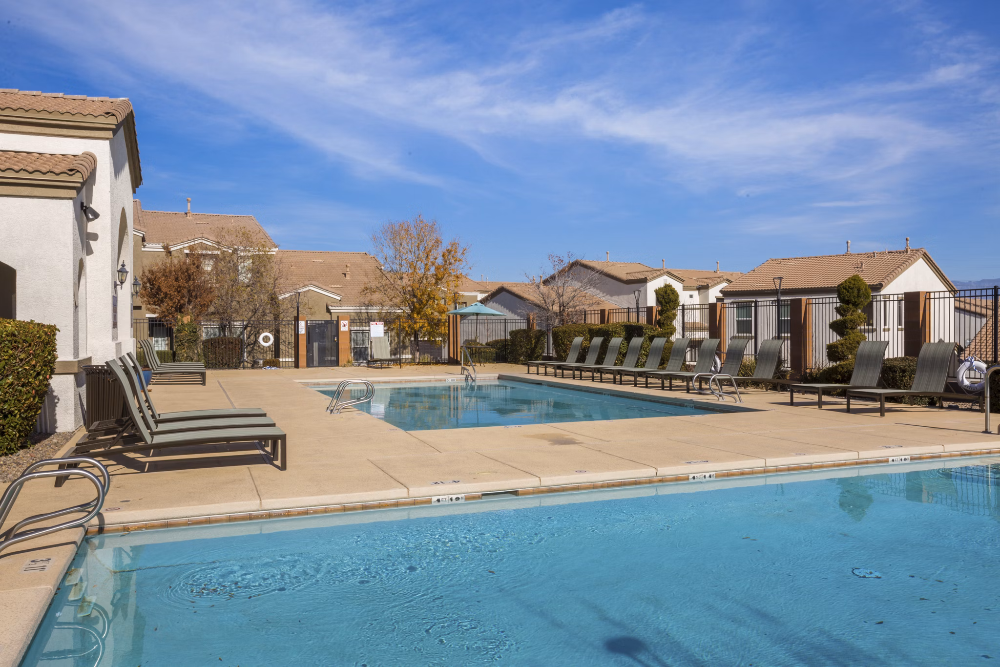 Inviting outdoor pool with sun loungers at Diamond Mesa Apartments
