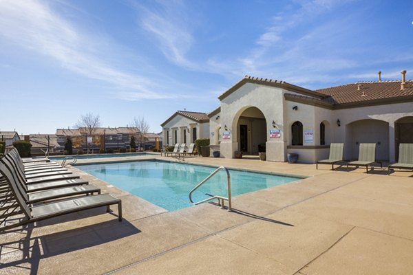 Resort-style pool with lounge chairs at Diamond Mesa Apartments