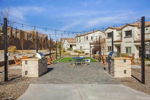 Outdoor BBQ grill area with seating at Diamond Mesa Apartments, offering community gathering space in a luxurious setting