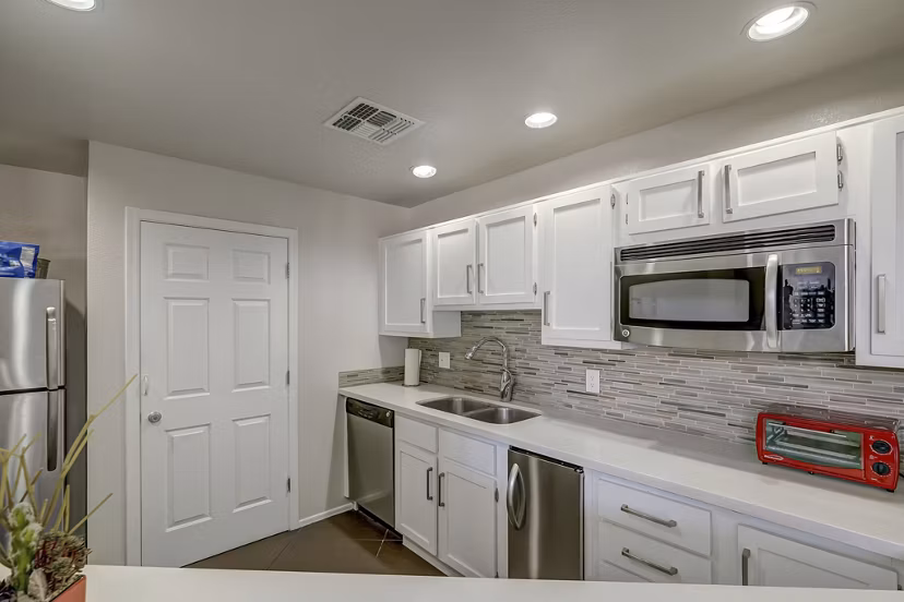Modern kitchen with stainless steel appliances at Allure at Tempe Apartments
