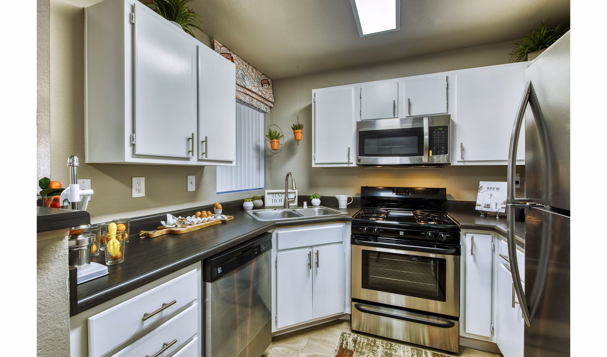 Modern kitchen with stainless steel appliances at Allure at Tempe Apartments
