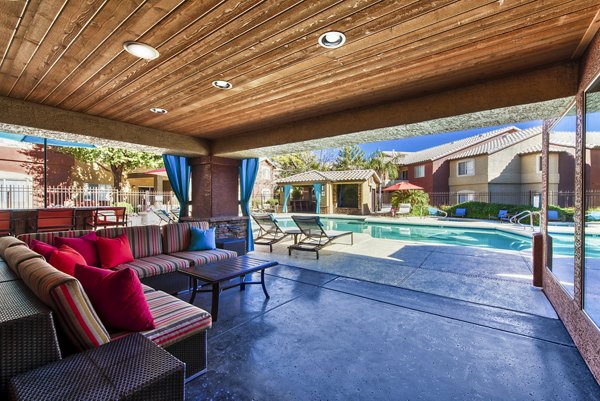 Relaxing pool patio with lounge chairs at Allure at Tempe Apartments, offering a tranquil outdoor retreat for residents