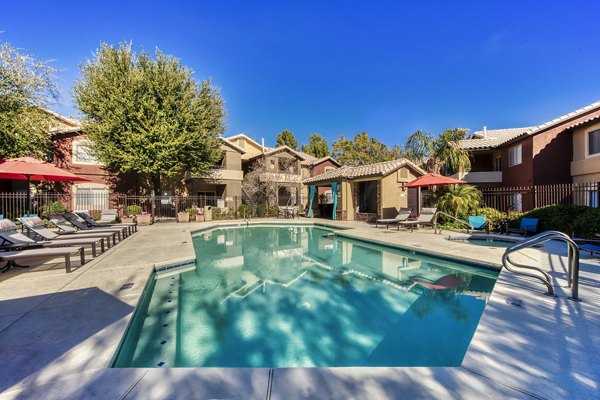 Poolside retreat with lounge chairs and palm trees at Allure at Tempe Apartments