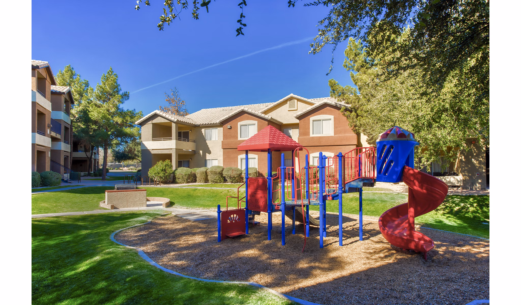 Colorful playground with slides and swings at Allure at Tempe Apartments, a luxury living community in Arizona
