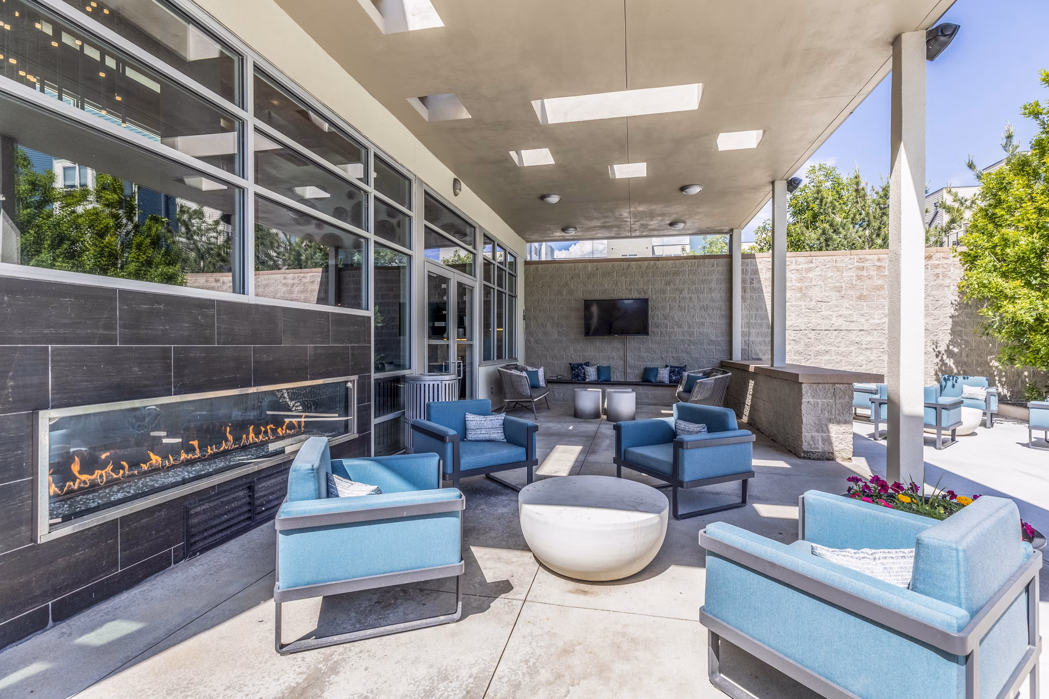 Fire pit and grill at Arista Uptown Apartments' patio, featuring cozy seating and outdoor dining options Perfect for gatherings and relaxation