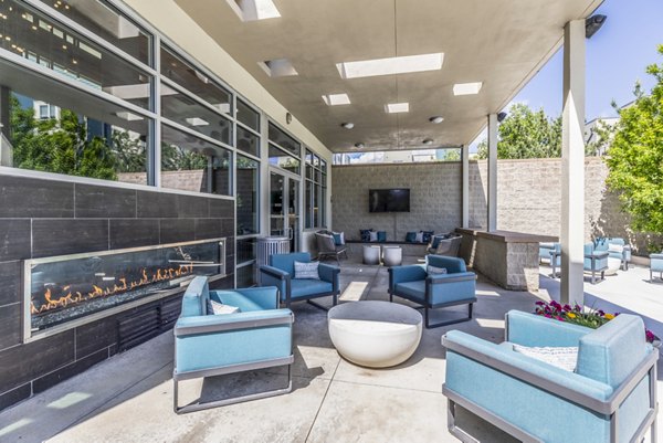 Fire pit and grill at Arista Uptown Apartments' patio, featuring cozy seating and outdoor dining options Perfect for gatherings and relaxation