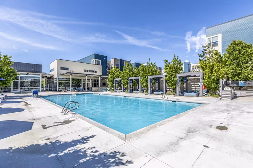 Sparkling outdoor pool at Arista Uptown Apartments offering luxury relaxation and leisure amenities to residents