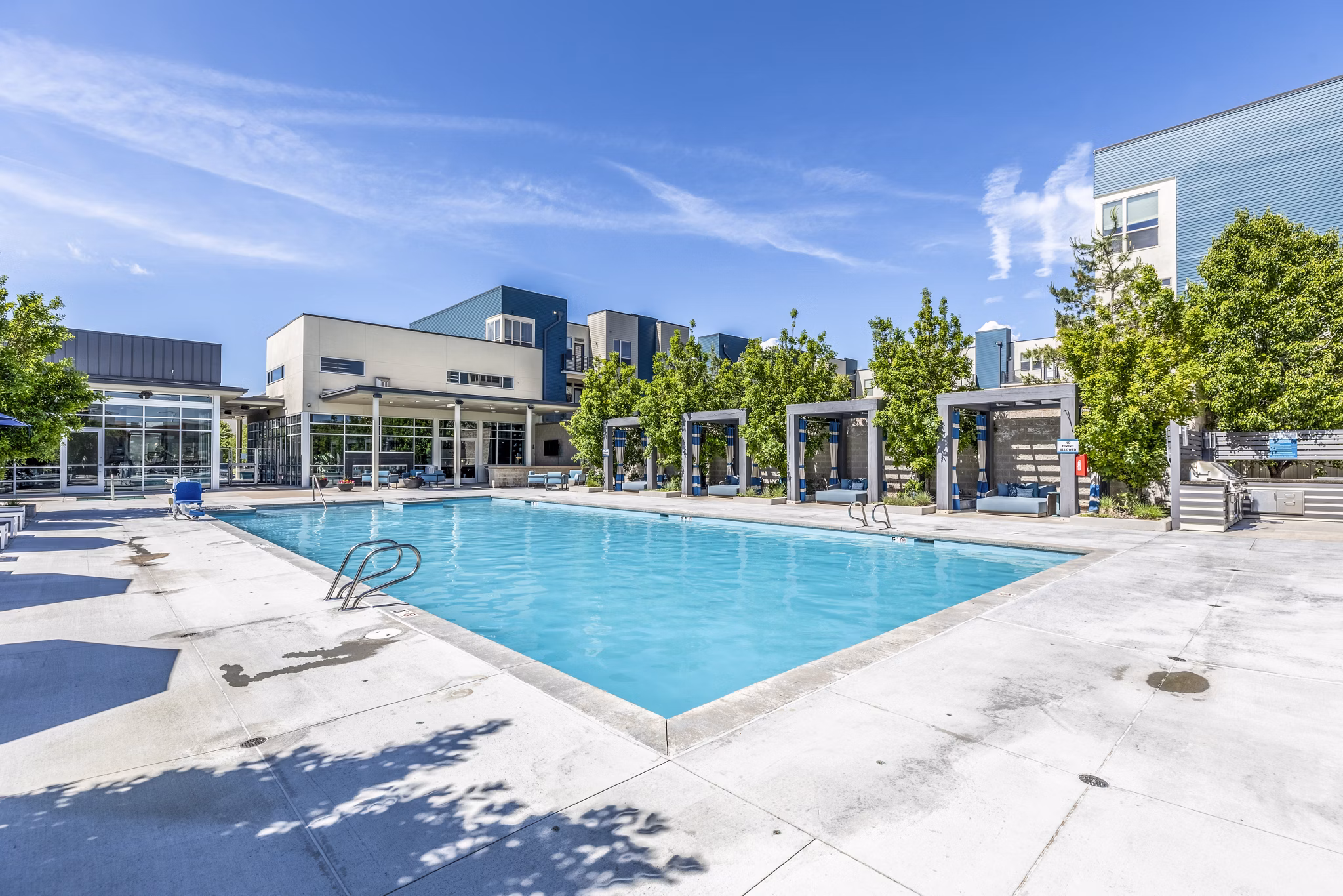 Sparkling outdoor pool at Arista Uptown Apartments offering luxury relaxation and leisure amenities to residents