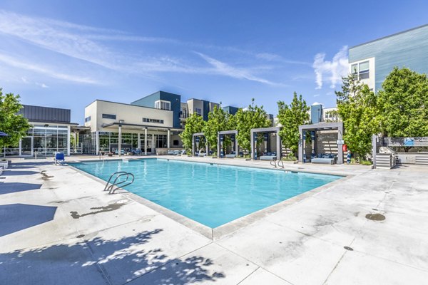 Sparkling outdoor pool at Arista Uptown Apartments offering luxury relaxation and leisure amenities to residents