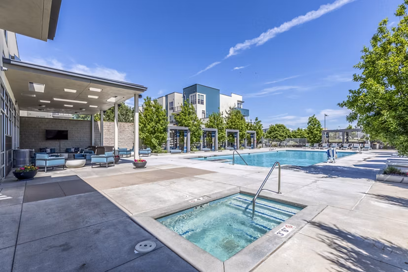 Jacuzzi with scenic views at Arista Uptown Apartments' luxury pool area