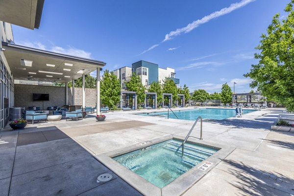 Jacuzzi with scenic views at Arista Uptown Apartments' luxury pool area