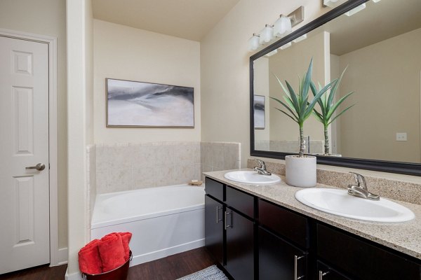 Luxurious bathroom with modern fixtures at Ladera Apartments featuring sleek design and ample natural light