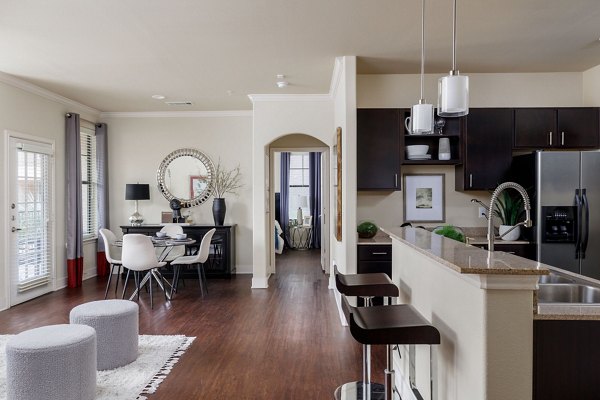 Modern kitchen with stainless steel appliances and granite countertops at Ladera Apartments, Greystar luxury property