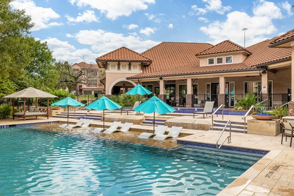 Pool with resort-style loungers at Ladera Apartments in Houston