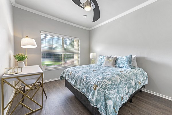 Luxurious bedroom featuring elegant decor and natural light at Barton Creek Villas Apartments, showcasing modern living