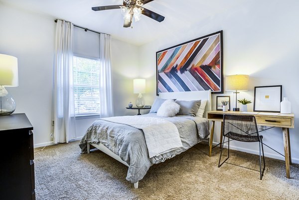 Bedroom with elegant decor and modern furnishings at The Vinoy at Innovation Park Apartments
