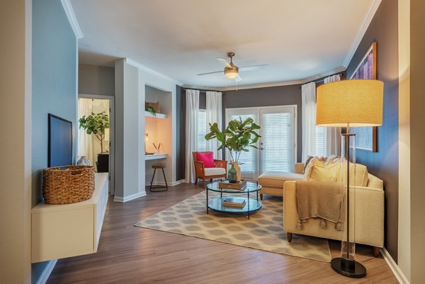 Spacious living room with modern dÃ©cor and natural light at The Vinoy at Innovation Park Apartments