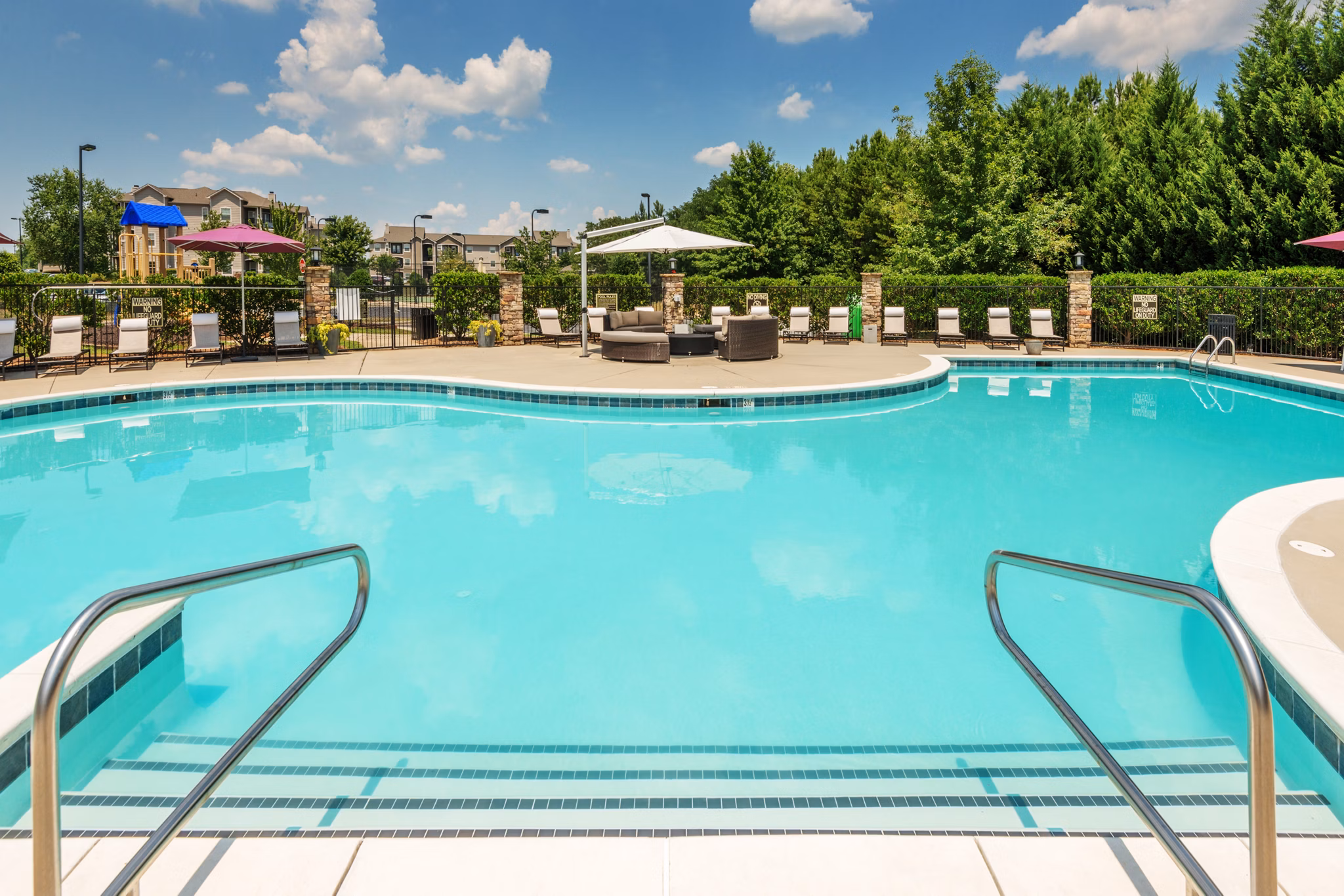 Inviting pool area with comfortable lounge chairs at The Vinoy at Innovation Park Apartments