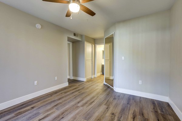 Cozy bedroom with large window and modern decor at Avana Desert View Apartments