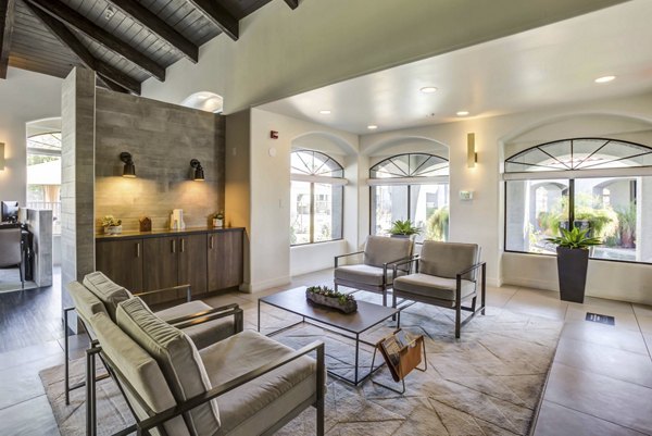 Avana Desert View Apartments: Modern clubhouse with luxurious seating and entertainment options in scenic Desert View location