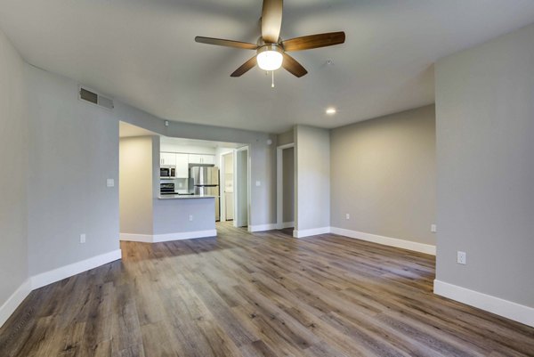 Spacious living room with modern decor and large windows in Avana Desert View Apartments