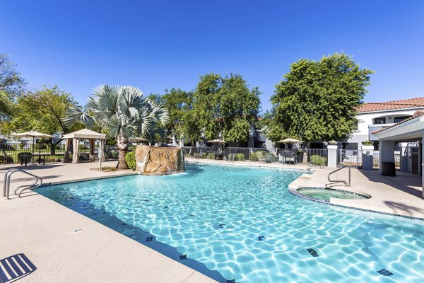 Resort-style pool with sun loungers at Avana Desert View Apartments offering luxury living in a serene desert setting