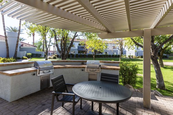 Modern grill area with outdoor seating at Avana Desert View Apartments, ideal for social gatherings and relaxation in a luxury setting