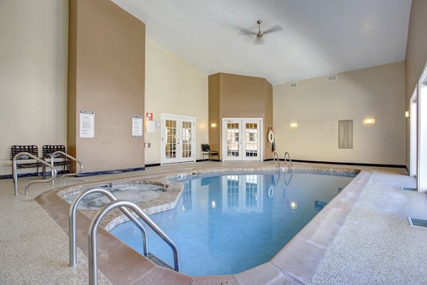 Outdoor pool with lounge chairs at Waterford Place Apartments, offering luxury amenities for relaxation and recreation