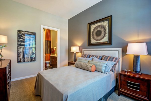 Modern bedroom with sleek furniture and soft lighting at Whitehall Parc Apartment Homes