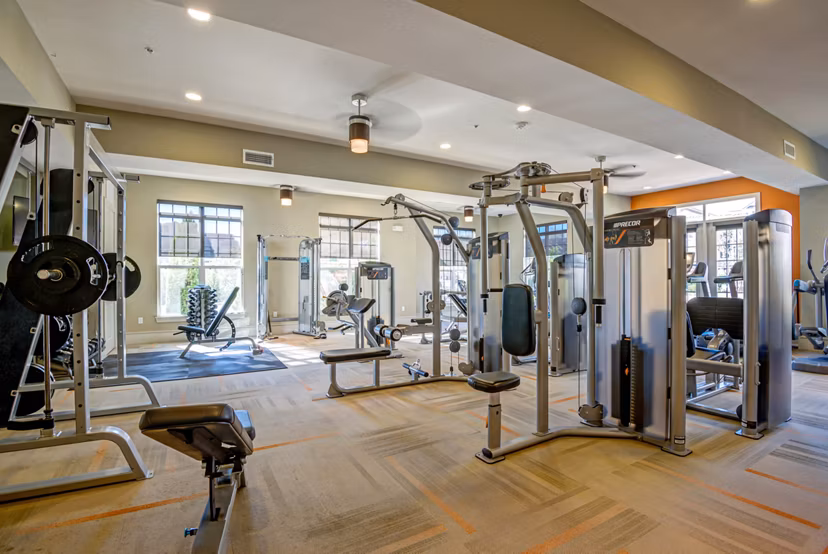Fitness center with state-of-the-art equipment at Whitehall Parc Apartment Homes offering residents a modern workout space