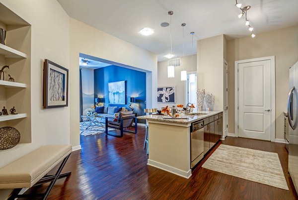 Modern kitchen with stainless steel appliances in Whitehall Parc Apartment Homes