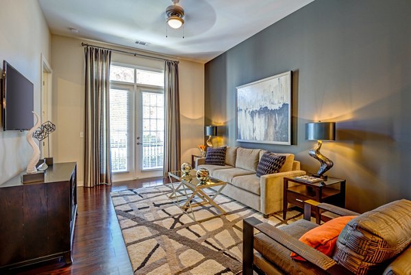 Spacious living room with contemporary furnishings at Whitehall Parc Apartment Homes