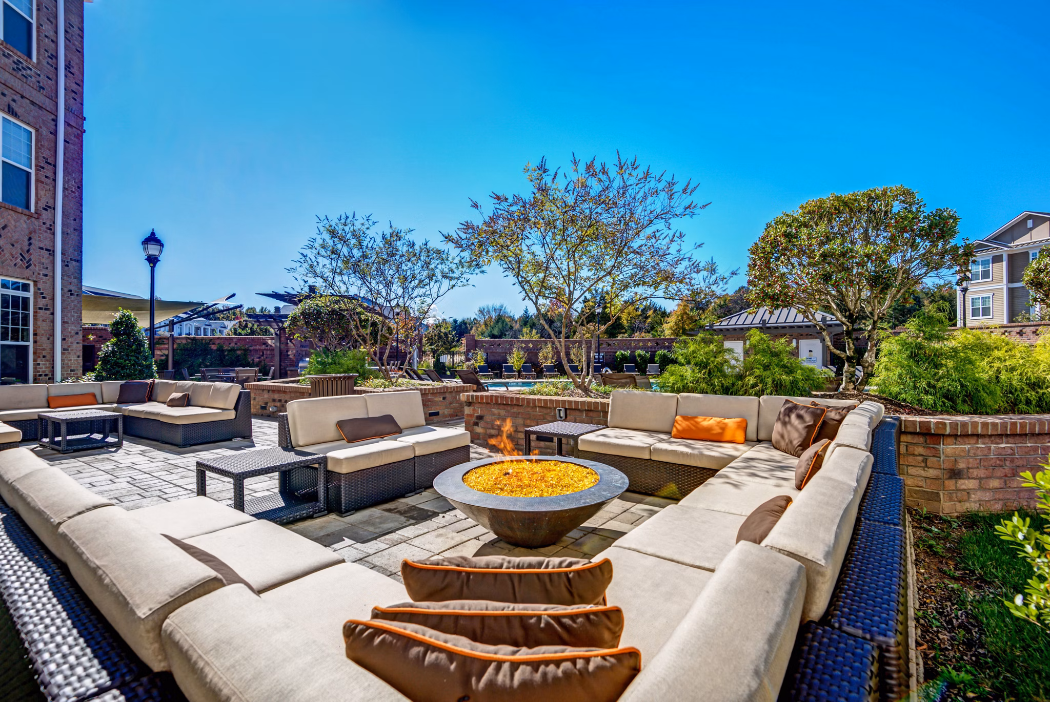 Outdoor grilling area with modern BBQ stations at Whitehall Parc Apartment Homes