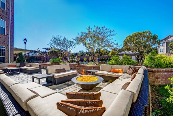 Outdoor grilling area with modern BBQ stations at Whitehall Parc Apartment Homes