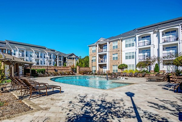 Resort-style pool with lounge chairs at Whitehall Parc Apartment Homes, perfect for relaxation and recreation