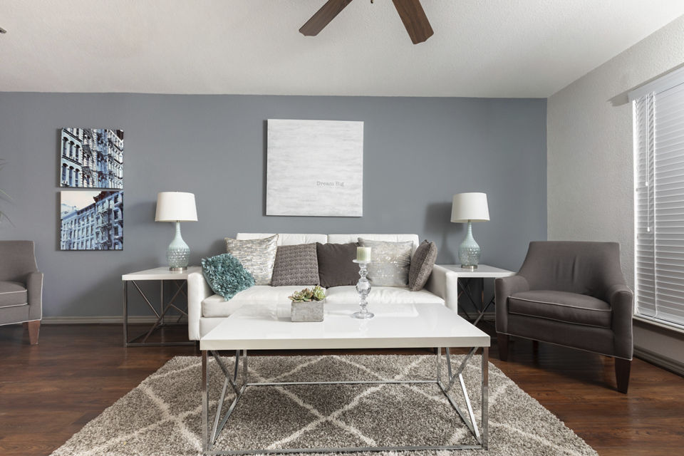 Spacious living room with modern decor and large windows in Reserve at Garden Oaks Apartments